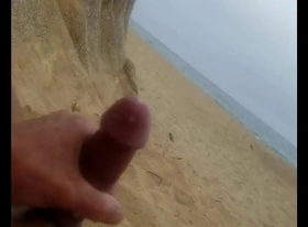 Beach masturbation with cumshot.